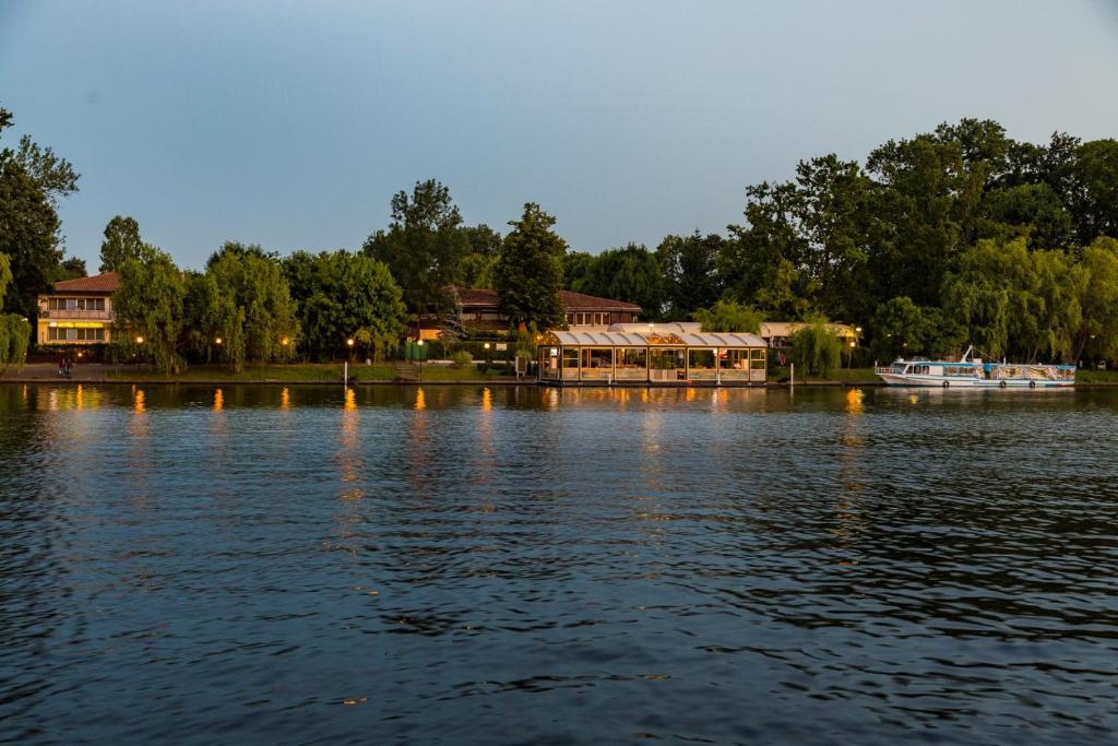 a large body of water with a boat in it at Hotel Herastrau in Bucharest