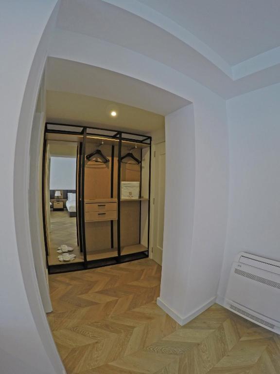 an empty living room with a hallway with a window at Prime Hotel in Tirana