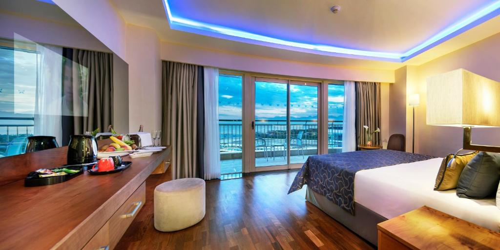 a hotel room with a bed and a balcony at Liberty Hotels Lara in Lara