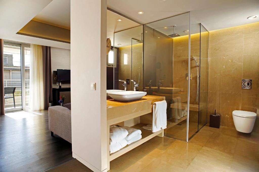 a bathroom with a sink and a shower at Hotel Lozenge in Athens