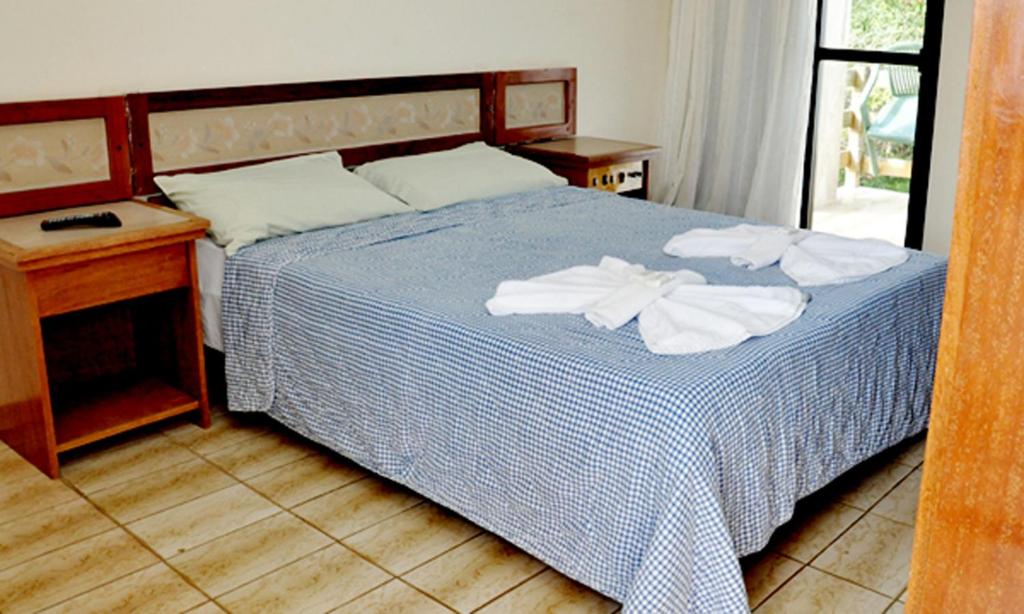 Postel nebo postele na pokoji v ubytování Pousada Enseada do Corsário