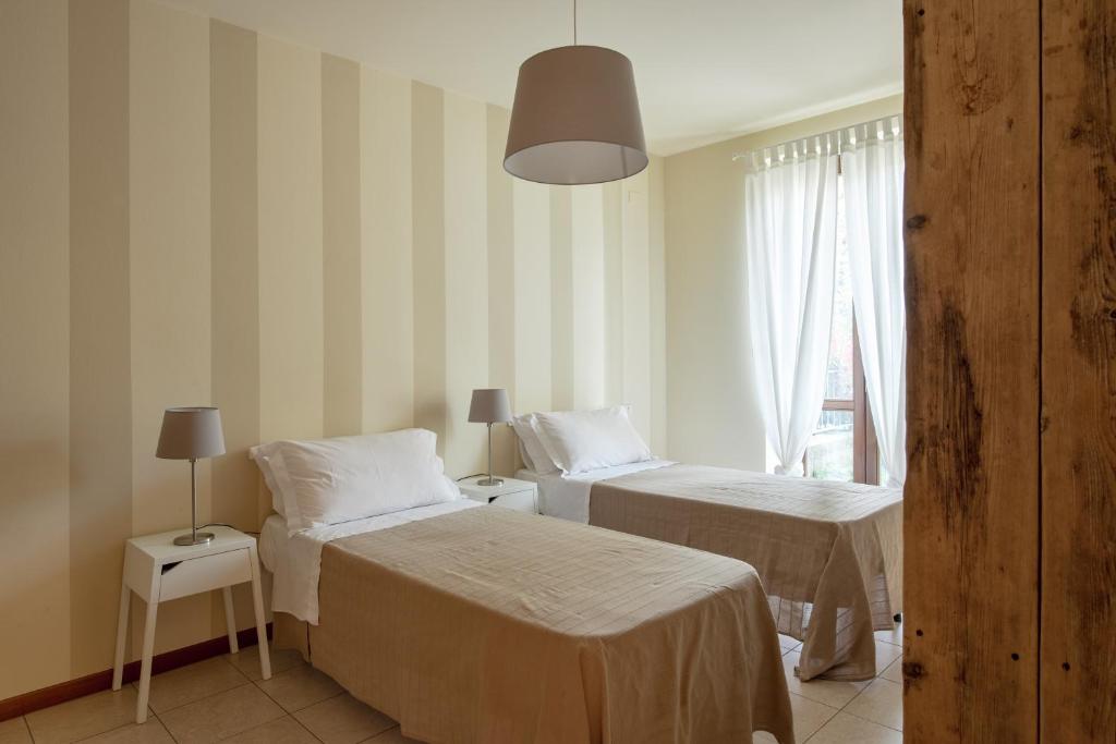 Postel nebo postele na pokoji v ubytování Appartamenti Corte Dei Cipressi