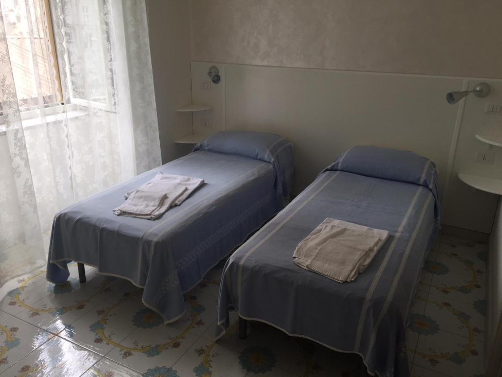 Postel nebo postele na pokoji v ubytování Albergo Oasi