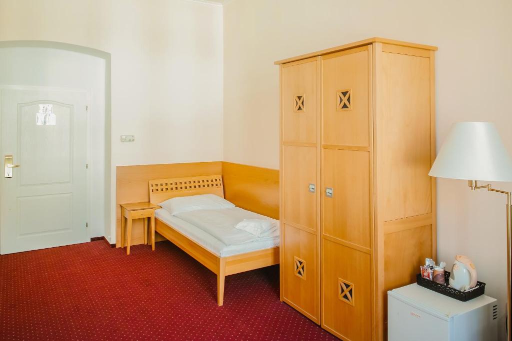 Postel nebo postele na pokoji v ubytování Hotel U Salzmannů