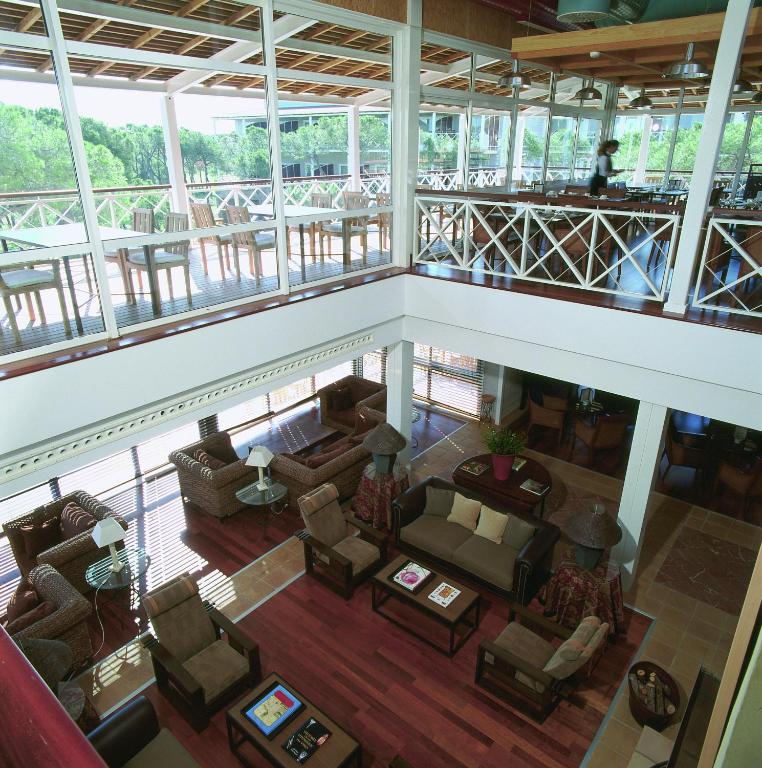 an overhead view of a living room with chairs and tables at Hotel Nuevo Portil Golf in El Rompido