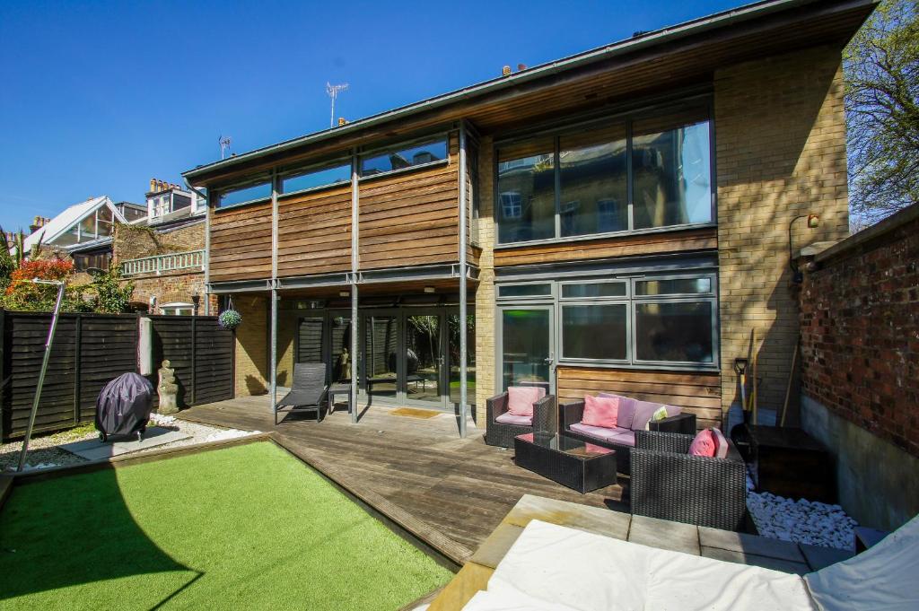 a house with a patio with a lawn at The Edge - Parking - by Brighton Holiday Lets in Brighton & Hove