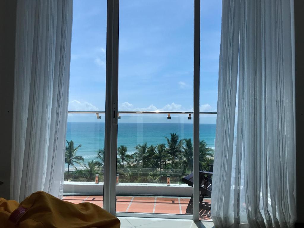 a view of the ocean from a hotel room at Araliya OceanFront Condos Nilaveli, Trincomalee in Nilaveli