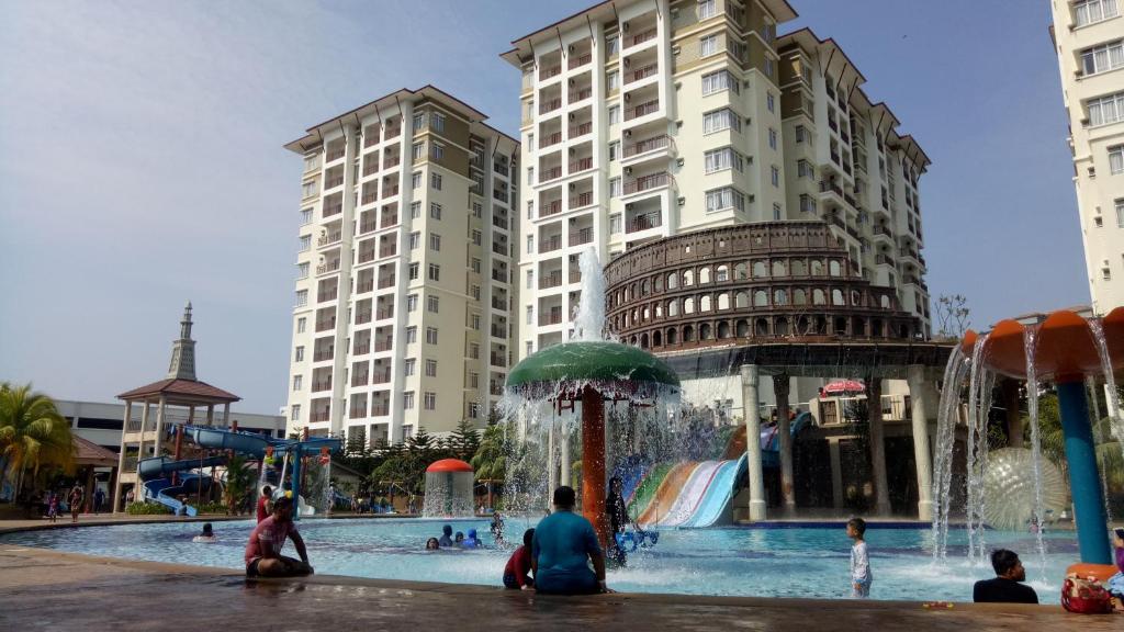 a group of people sitting around a water park at CT Homestay at Lagoon Park Resort in Melaka