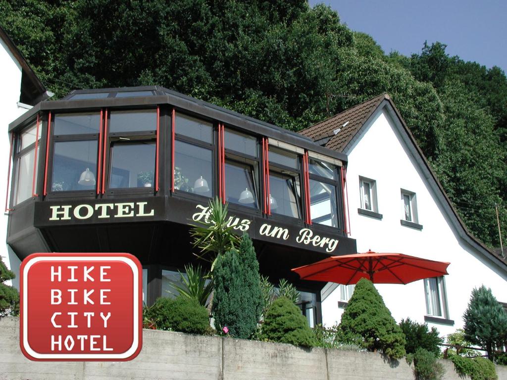 a house with a hotel sign in front of it at Hotel Haus am Berg in Trier