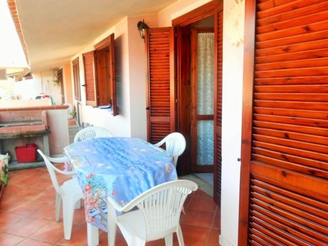 a table and chairs on the porch of a house at Casa Relax in Villasimius