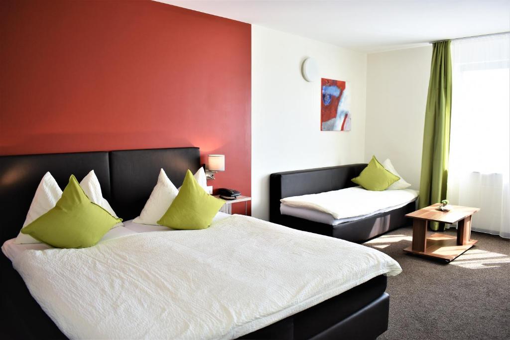 Postel nebo postele na pokoji v ubytování Hotel AM Schloss