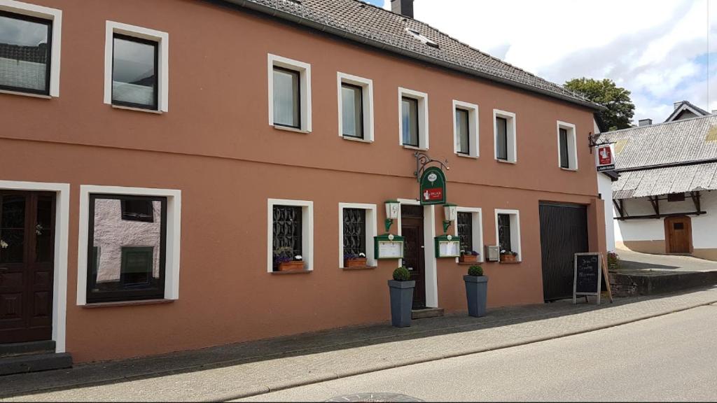 a building on a street next to a road at Landgasthof Em Lade in Dahlem