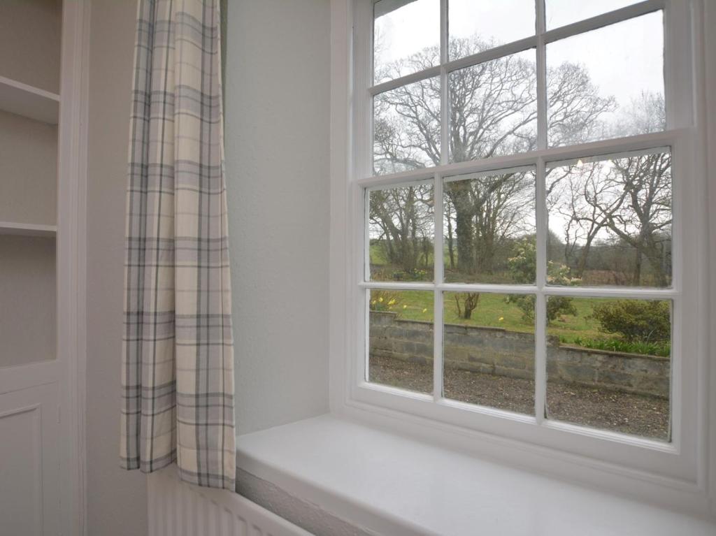 a window with a view of a garden at Pengarreg Fawr in Llanilar