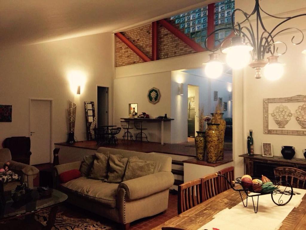 a living room with a couch and a table at Condominio parque dos eucaliptos in Itaipava