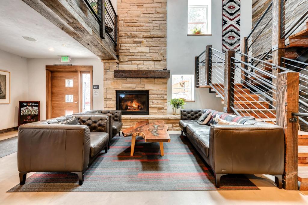 a living room filled with furniture and a fire place at A-Lodge Boulder in Boulder