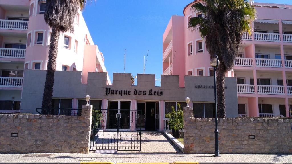 un edificio rosa con un cartello che legge "Hurricane Dusalley" di Monte Gordo T1 Parque dos Reis a Monte Gordo