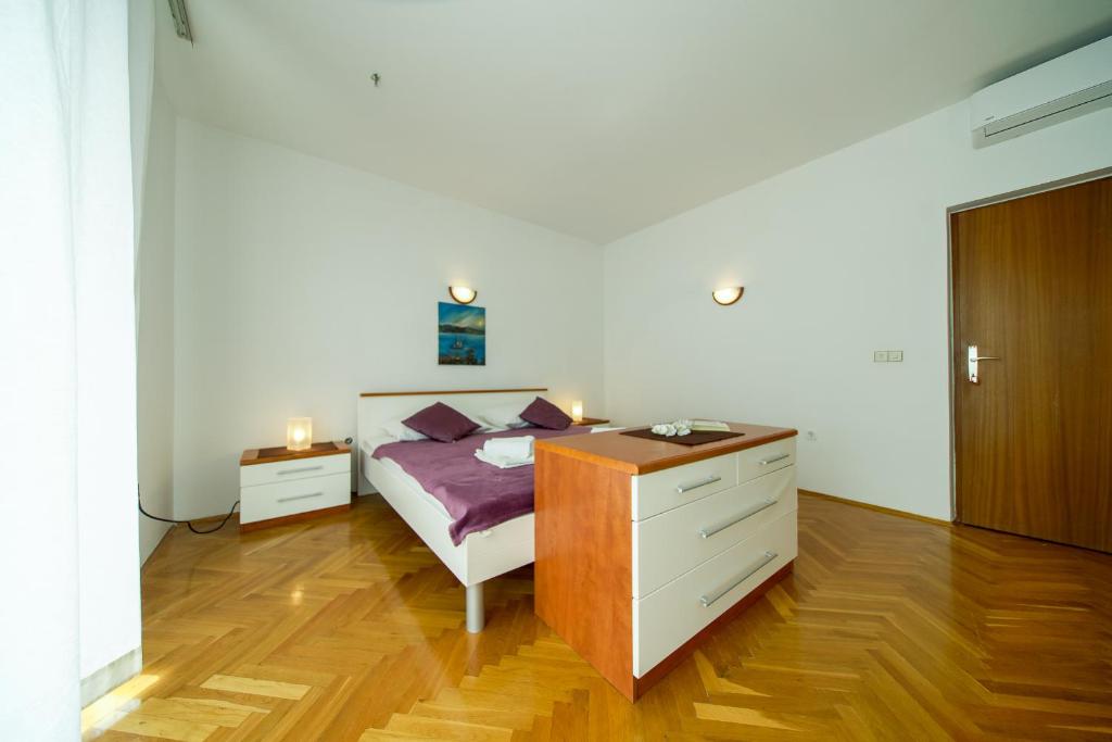 Posteľ alebo postele v izbe v ubytovaní Apartments L&L