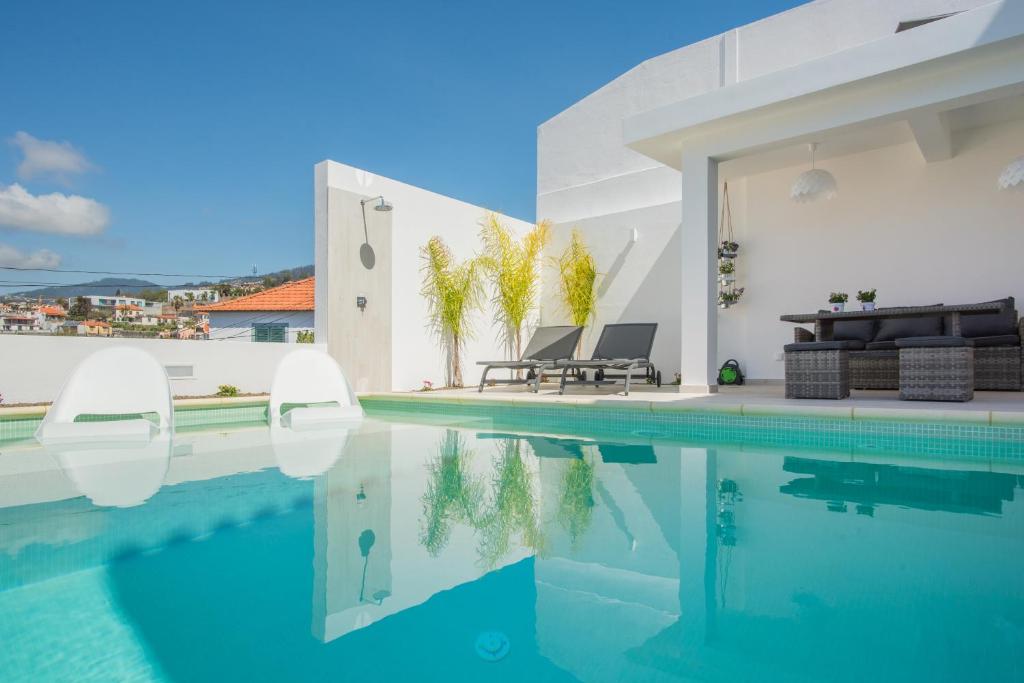 a villa with a swimming pool and a house at Susy’s Garden in Funchal