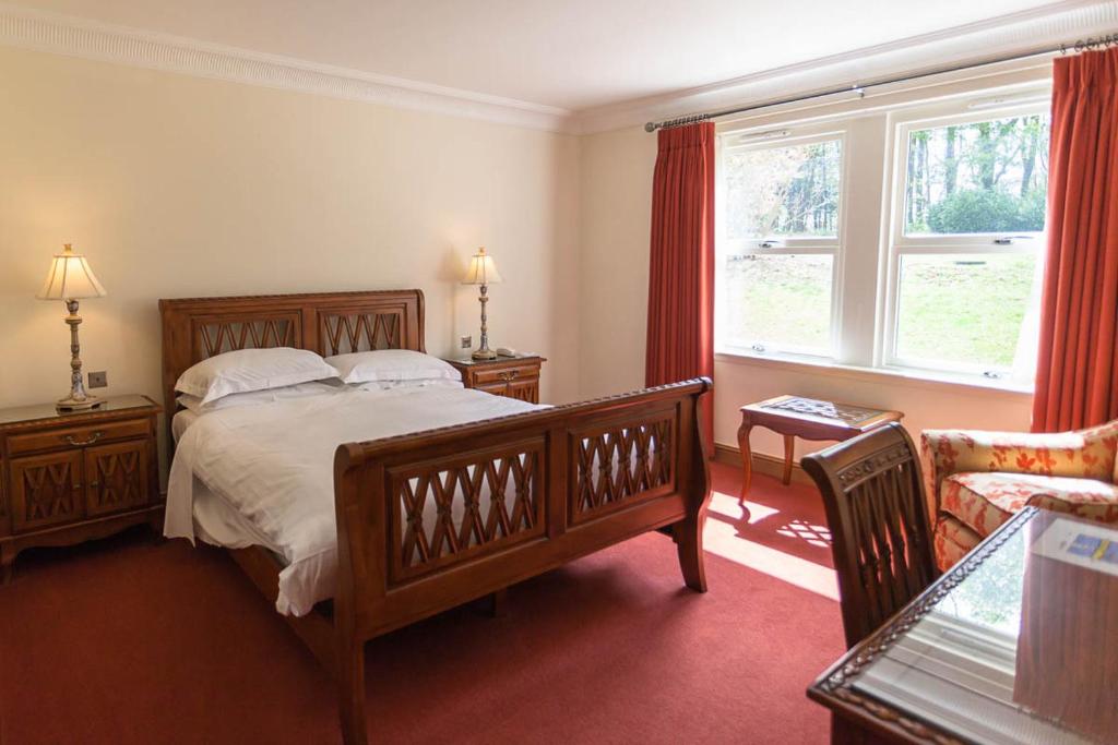 Ένα ή περισσότερα κρεβάτια σε δωμάτιο στο Woodland House Hotel