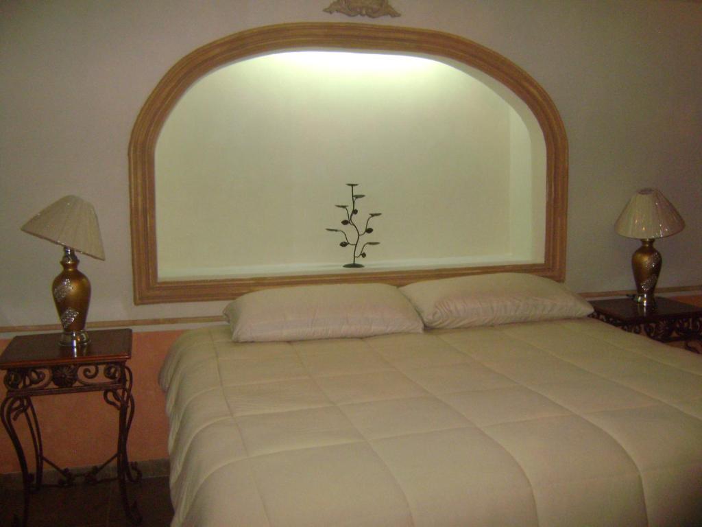 Postel nebo postele na pokoji v ubytování Hotel Posada Maria Bonita