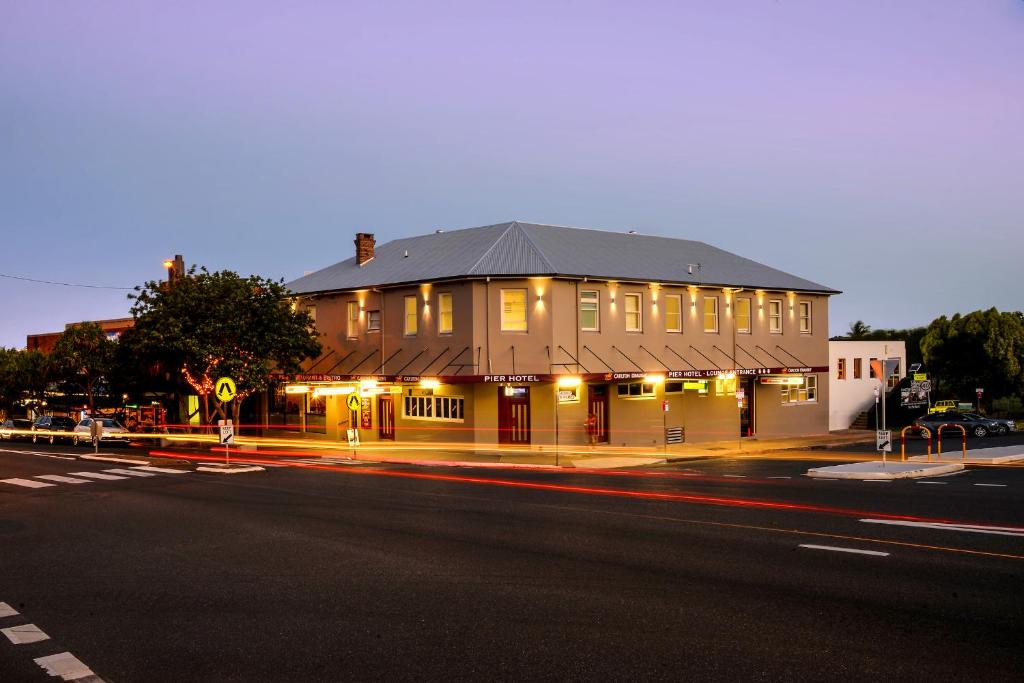 a large building with a clock on the front of it at Pier Hotel Coffs Harbour in Coffs Harbour