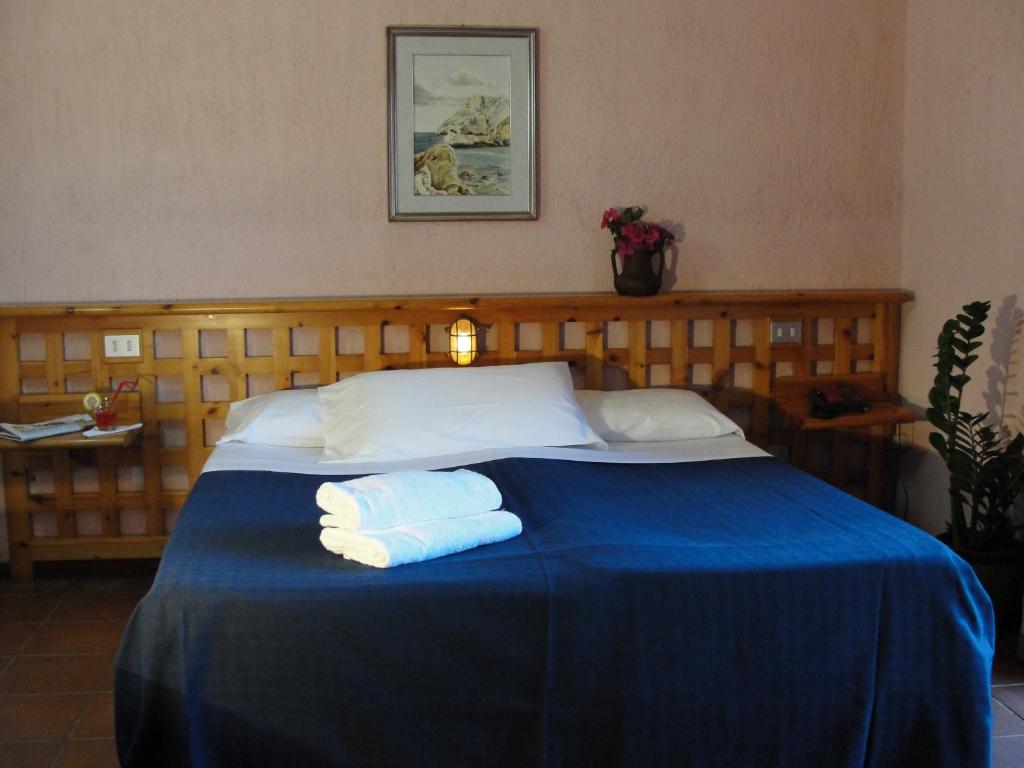 Postel nebo postele na pokoji v ubytování Hotel Scintilla