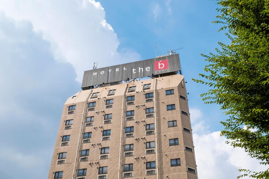 a building with a sign on the top of it at the b sangenjaya in Tokyo