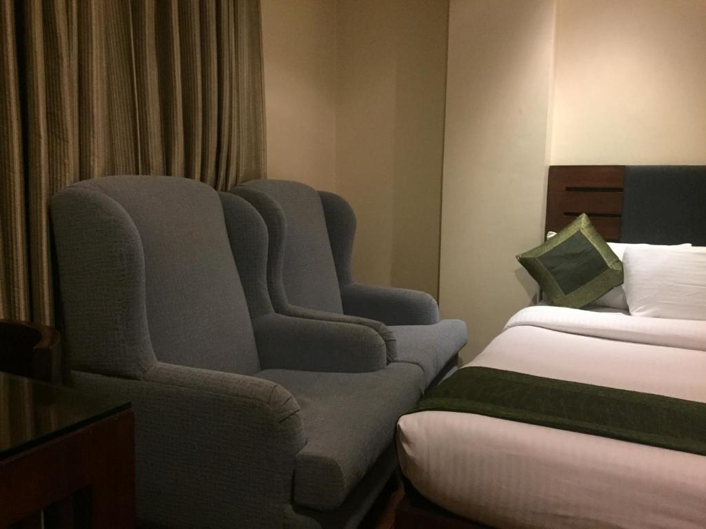 Postel nebo postele na pokoji v ubytování Hotel Aura - New Delhi Railway Station