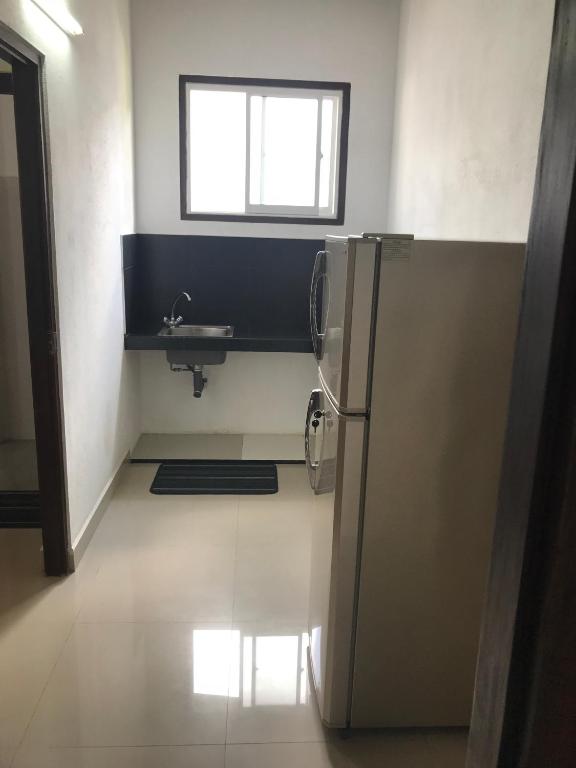 a kitchen with a sink and a refrigerator at Unawatuna Beach Bungalow - in Unawatuna