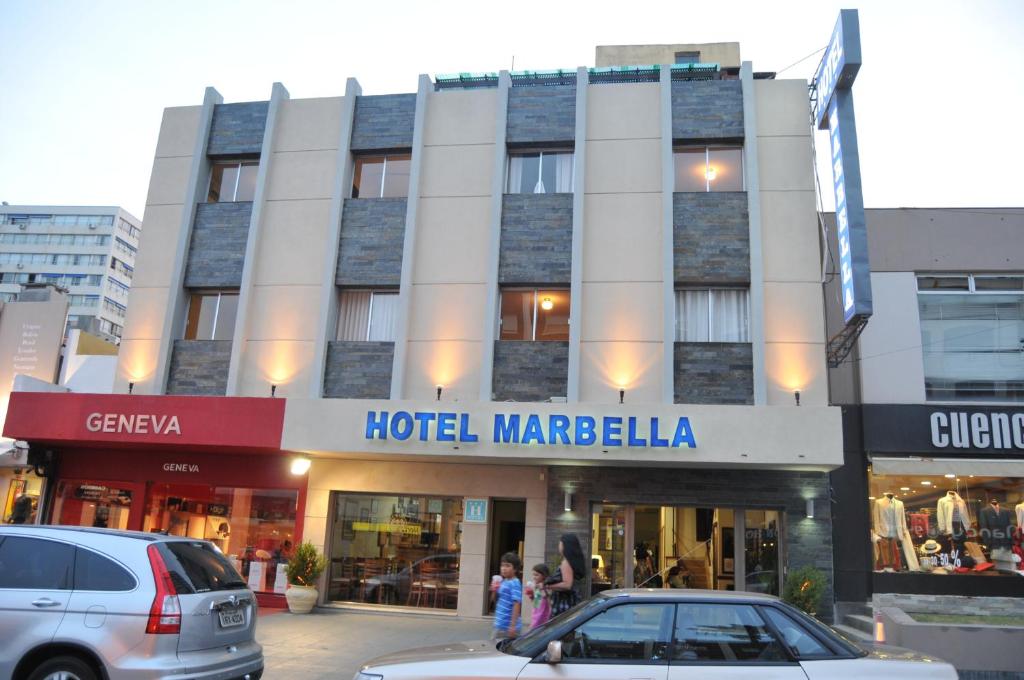 a hotel margelkaela in a city with cars parked in front at Hotel Marbella in Punta del Este