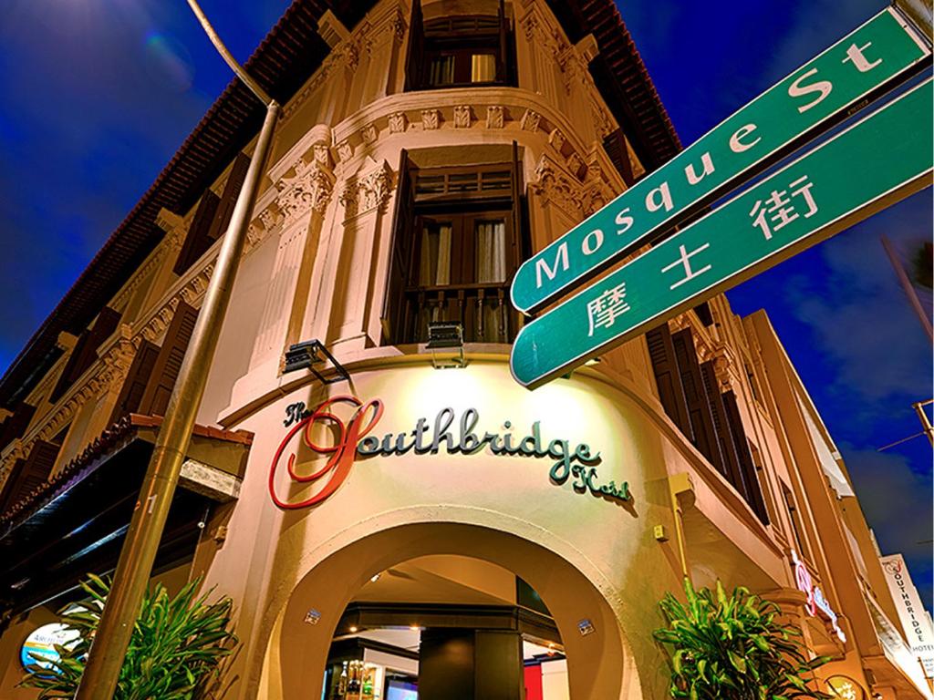 a street sign in front of a building at The Southbridge Hotel in Singapore