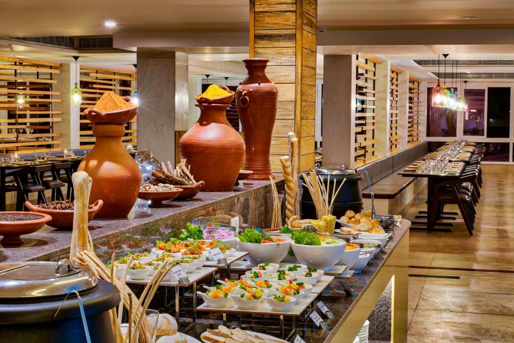 a buffet in a restaurant with many different foods at Sterling Wayanad in Sultan Bathery