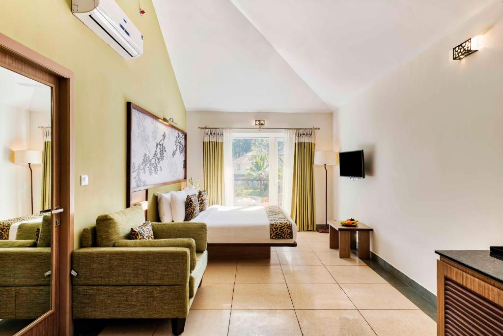 a large hotel room with a bed and a bedroom at Sterling Wayanad in Sultan Bathery