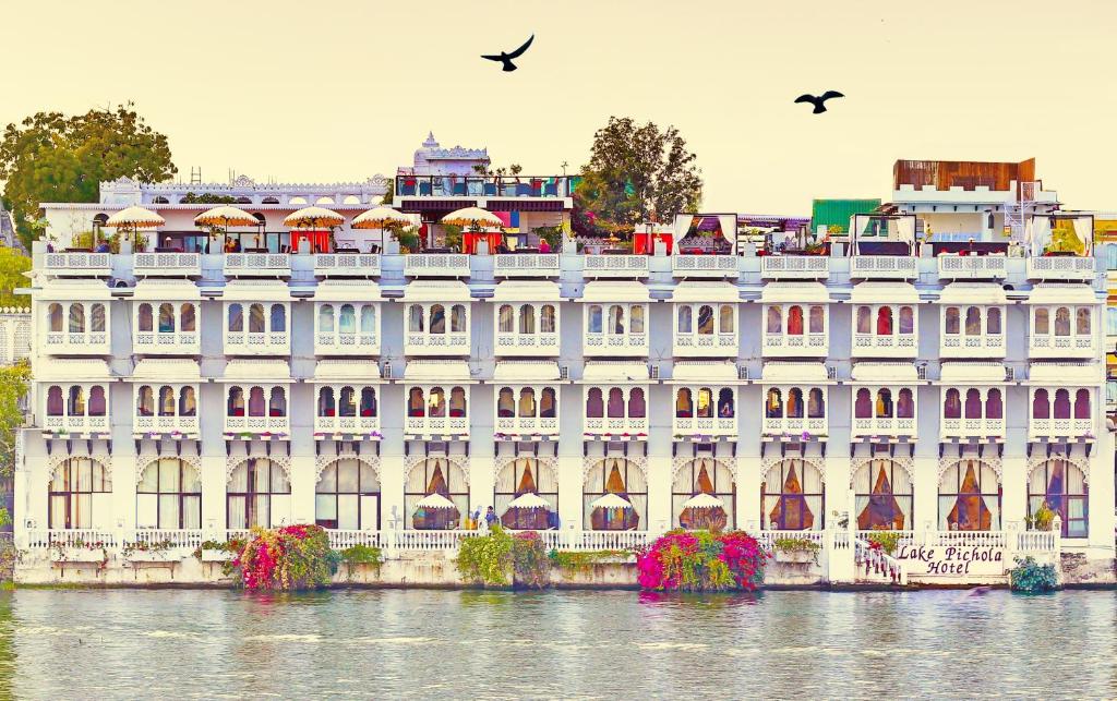 
a large building with a large clock tower in front of it at Lake Pichola Hotel in Udaipur
