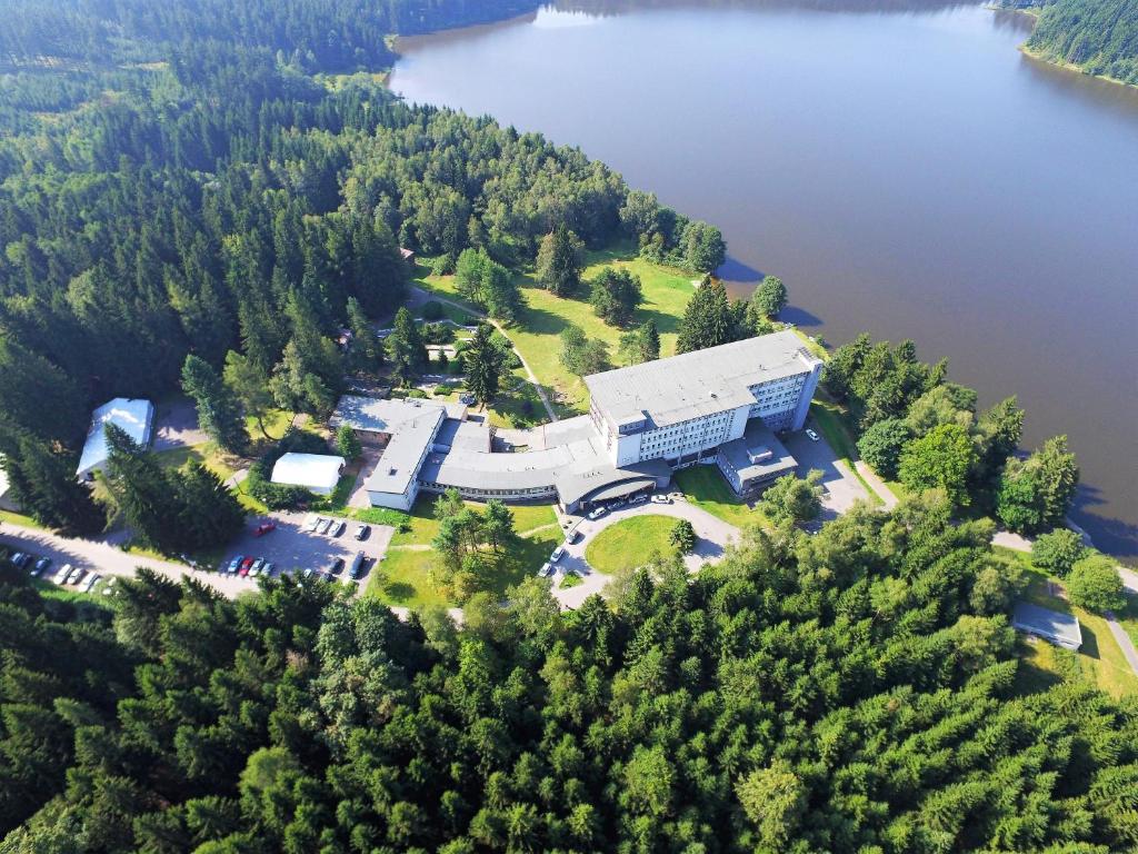 an aerial view of a building next to a lake at Hotel Medlov Depandance in Fryšava