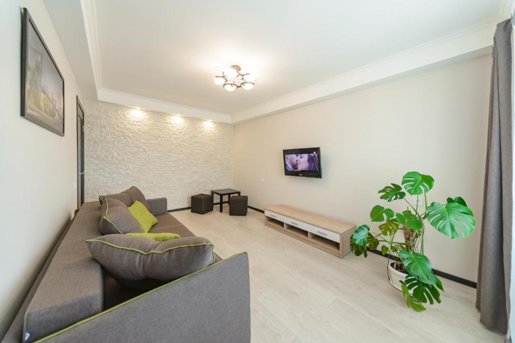 a living room with a couch and a table at ARTAL Apartment on Iordanskaya 22 in Kyiv