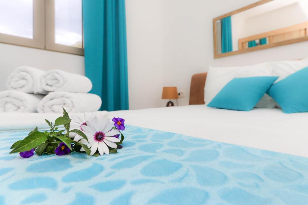 a bedroom with a bed with flowers on it at Apartments Castello in Kotor