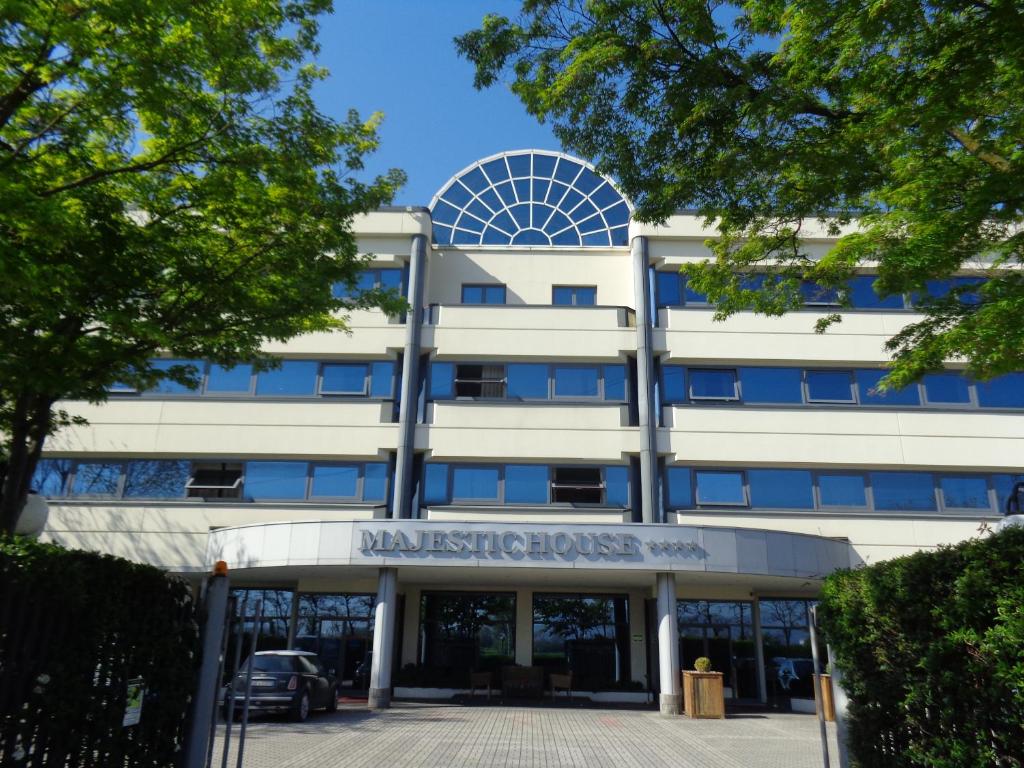 a large white building with a sign in front of it at Ferretti MajesticHouse in Castenedolo