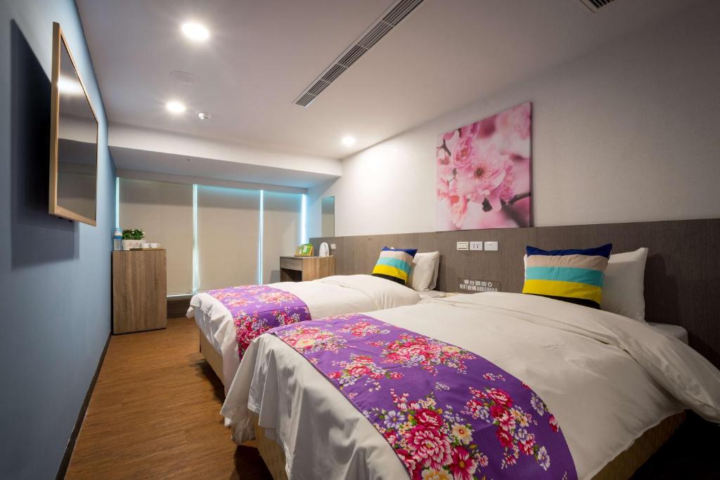 2 camas en una habitación de hotel con en Wish Hotel en Zhongli