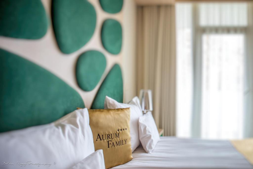 Postel nebo postele na pokoji v ubytování Hotel Aurum Family "A"