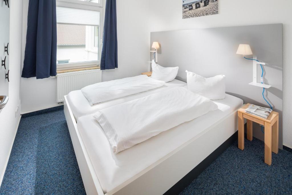 Postel nebo postele na pokoji v ubytování Haus KLIPPER Norderney
