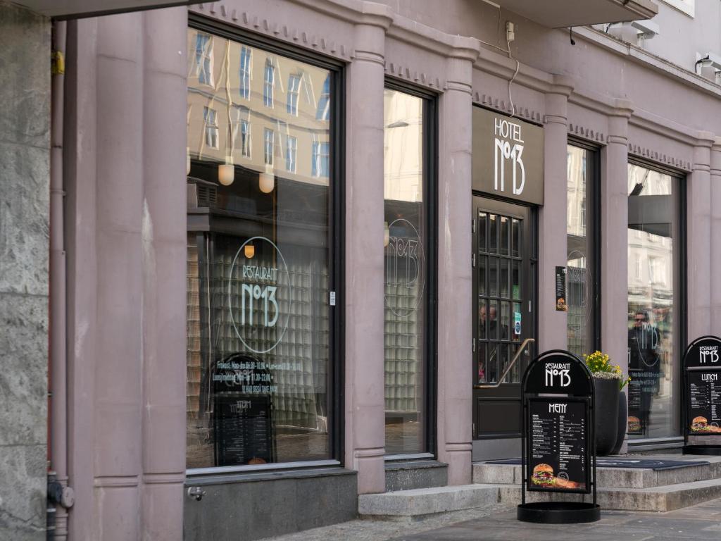 a store front with glass windows on a street at Hotel No13 in Bergen