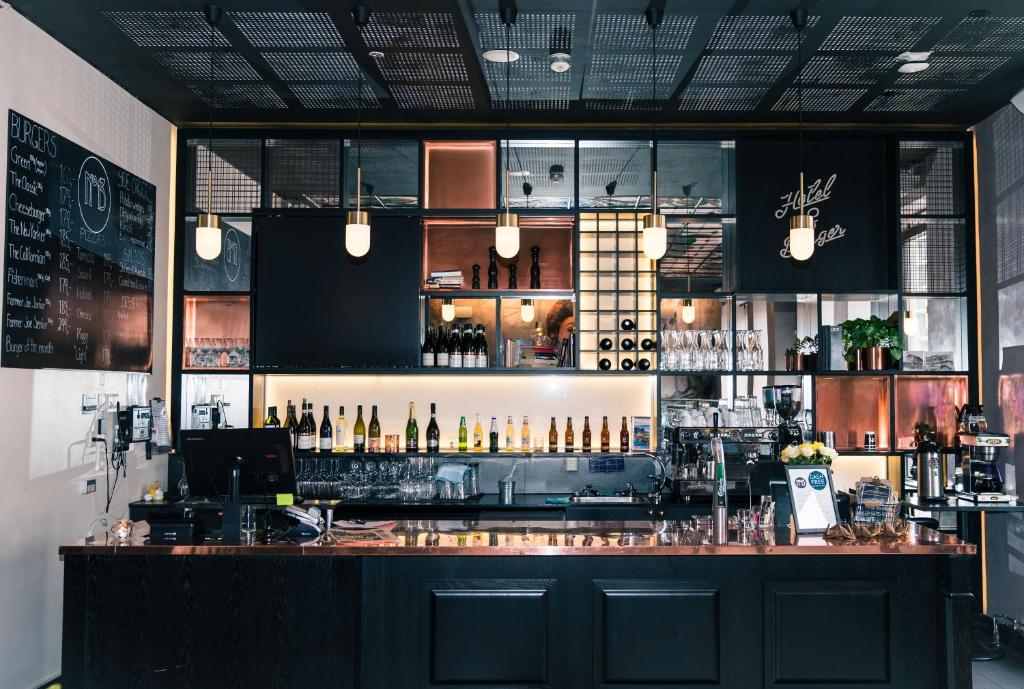 a bar in a restaurant with a lot of bottles at Hotel No13 in Bergen