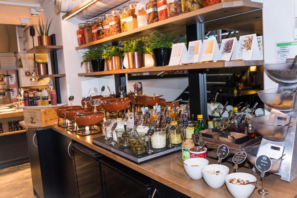 a counter in a store with a bunch of jars at Hotel No13 in Bergen