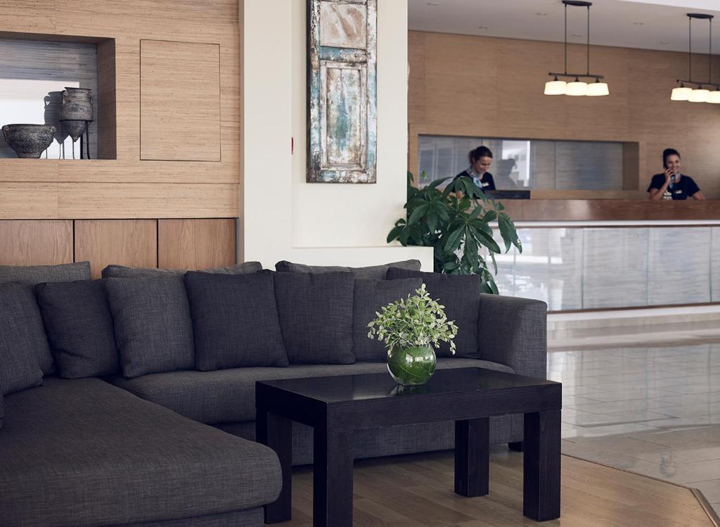 a living room with a couch and a table at Pefki Islands in Pefki