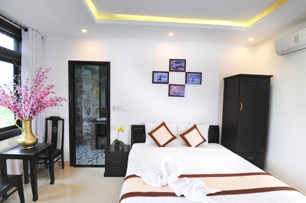 Postel nebo postele na pokoji v ubytování Hoi An Bali Homestay
