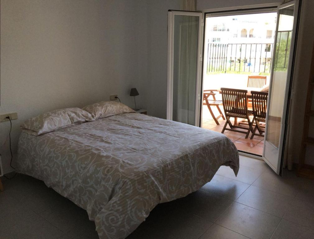 sypialnia z łóżkiem i drzwiami prowadzącymi na patio w obiekcie Apartamento Elia Villa África w mieście Aguadulce