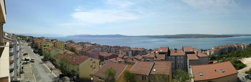 a view of a town with a river and houses at Apartman Una in Crikvenica