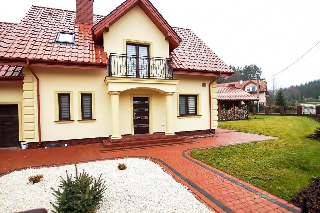 a house with a brick walkway in front of it at Villa Nad Jeziorem in Kruklanki