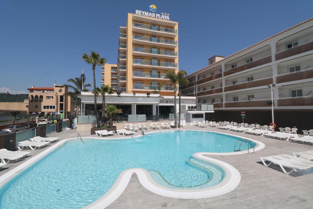 a large swimming pool in front of a hotel at Hotel Reymar Playa in Malgrat de Mar